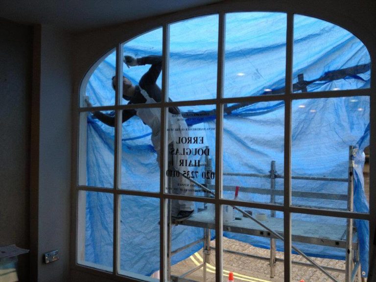 Invisible Painters refurbishing intricate window frame